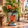 Hand-painted Mexican Talavera planter (TCTP550) with green foliage and flowering plants.
