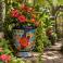 Mexican Talavera planter (TCTP550) styled with lush greenery and flowering plants.