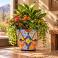 Mexican Talavera planter (TP440) displayed with green foliage and colorful flowers.