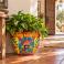 Medium Talavera planter (TP245B), handcrafted in Mexico, shown with green foliage.
